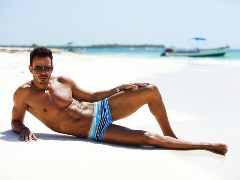 Stylish man wearing sunglasses in a beach.