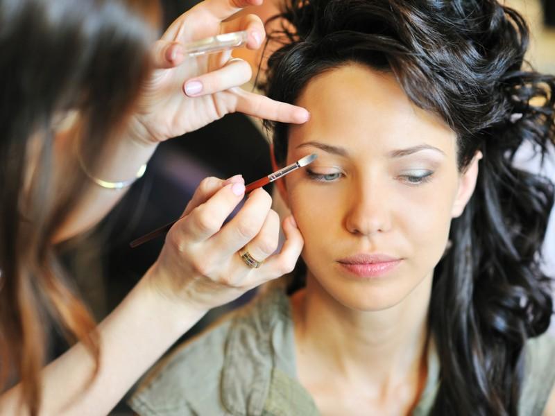 Makeup artist applying makeup.