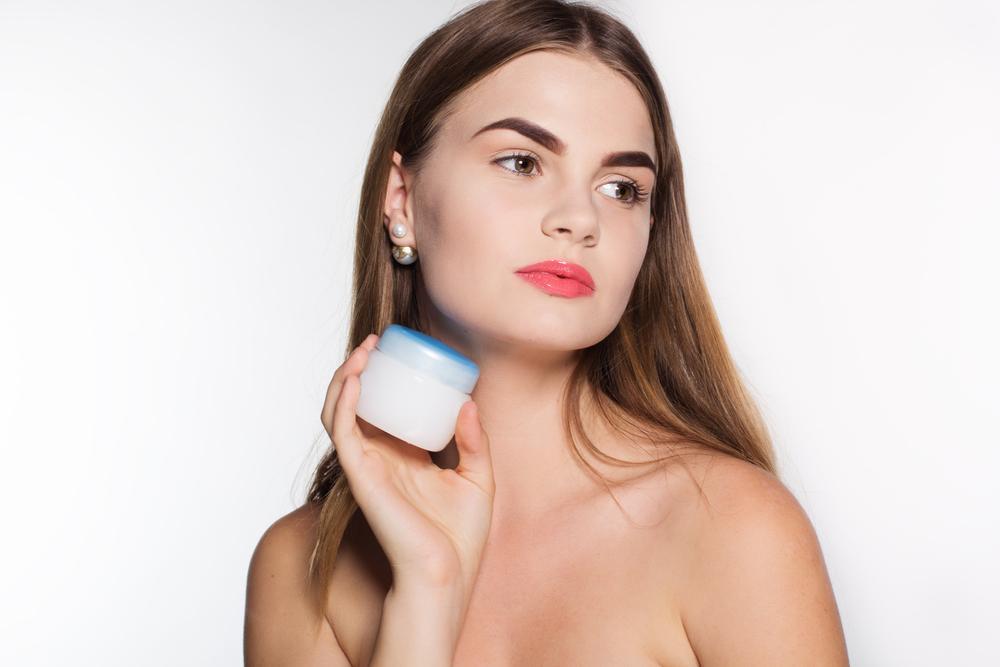 Woman holding a skin care product