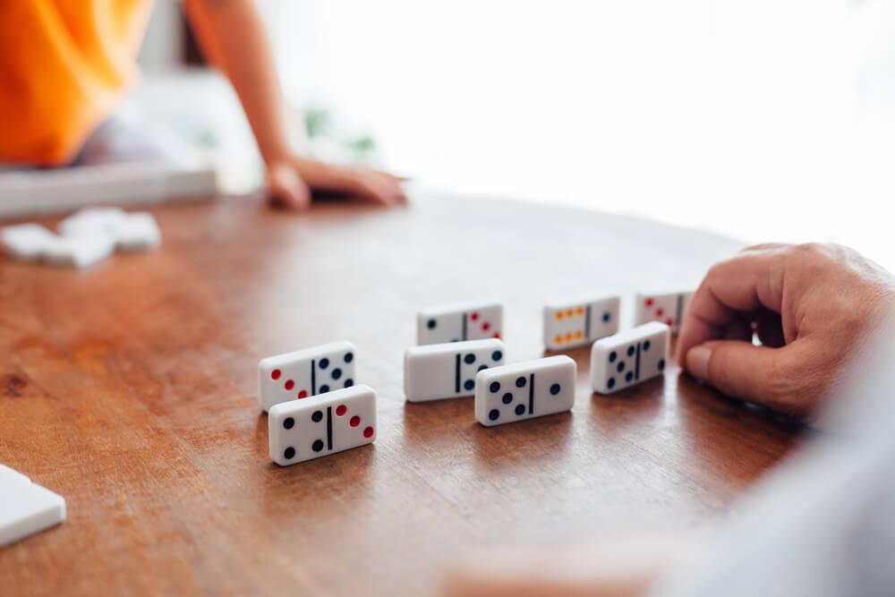 Hands playing dominoes