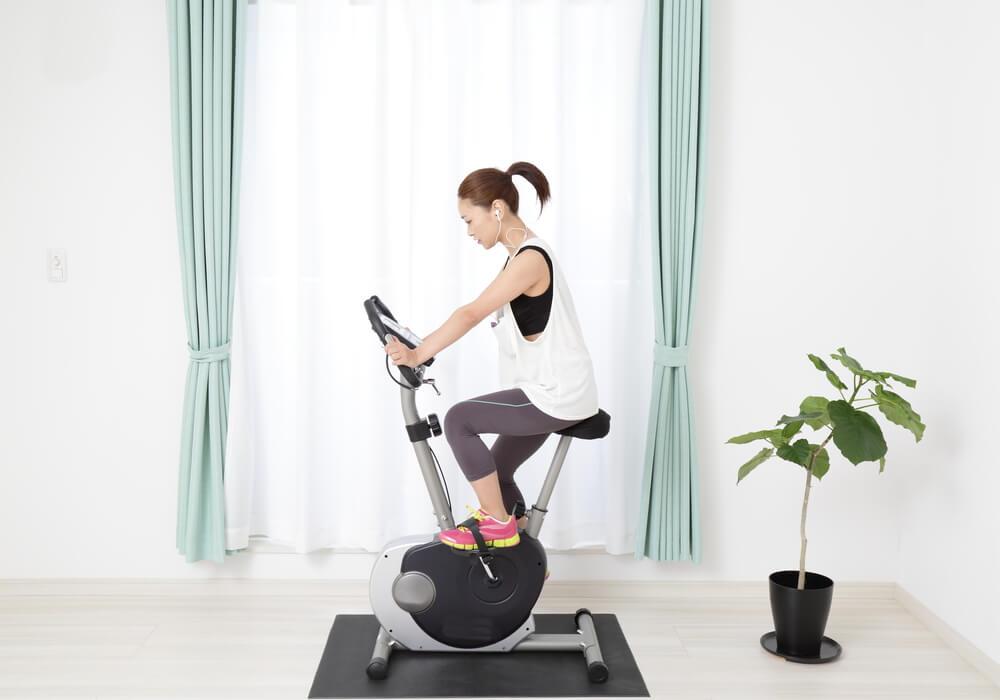Woman on exercise bike at home