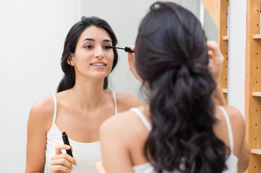 Woman applying mascara