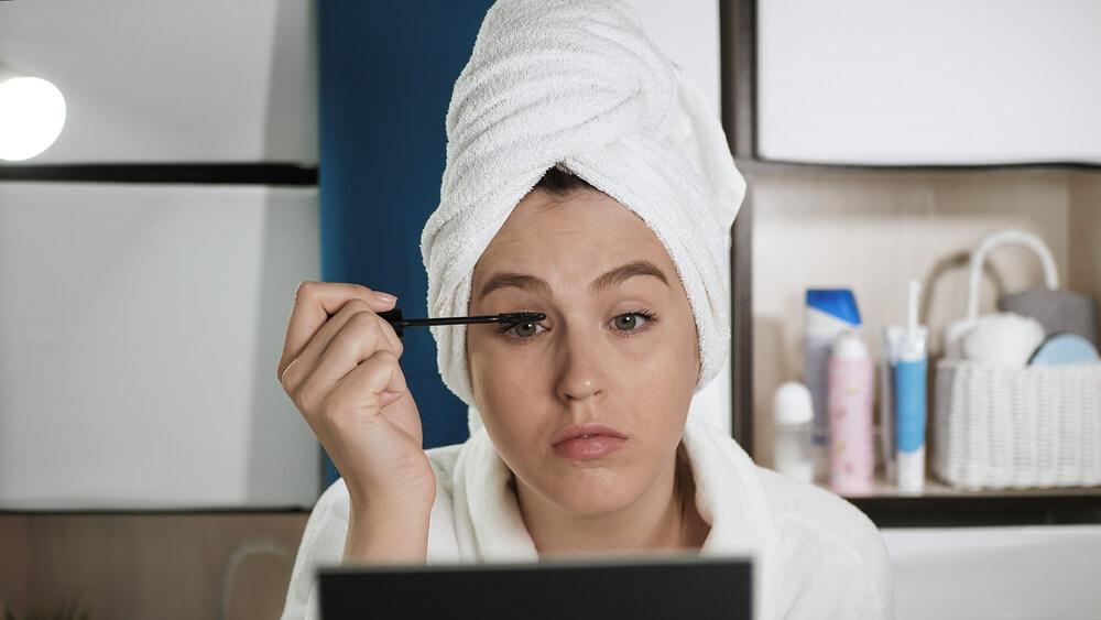 Woman applying mascara