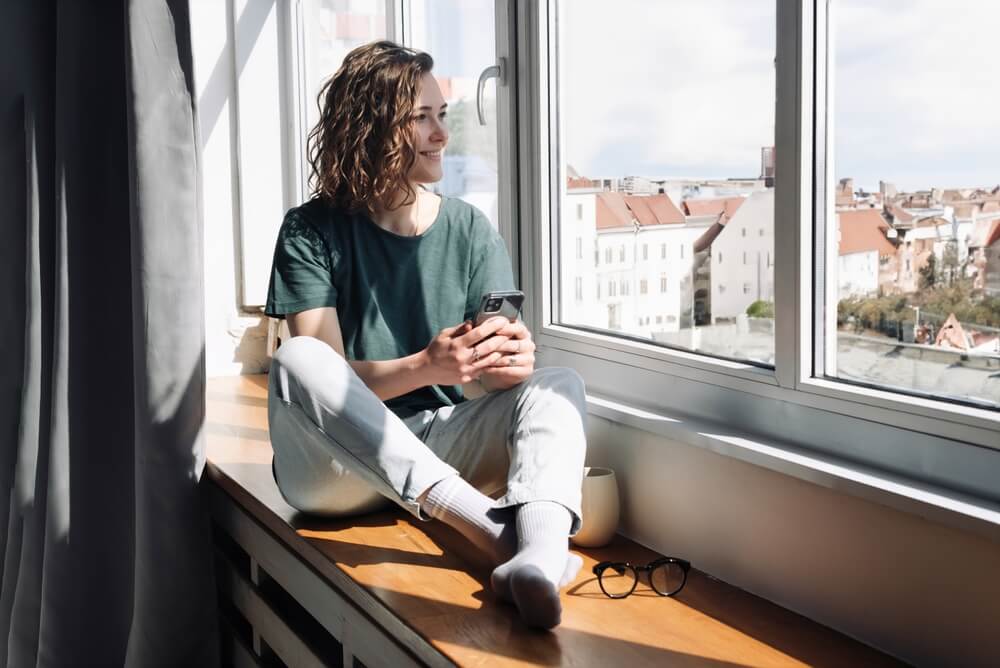 woman looking out window