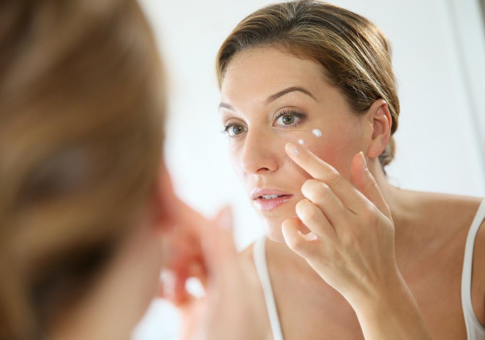 Woman applying anti-aging wrinkle cream