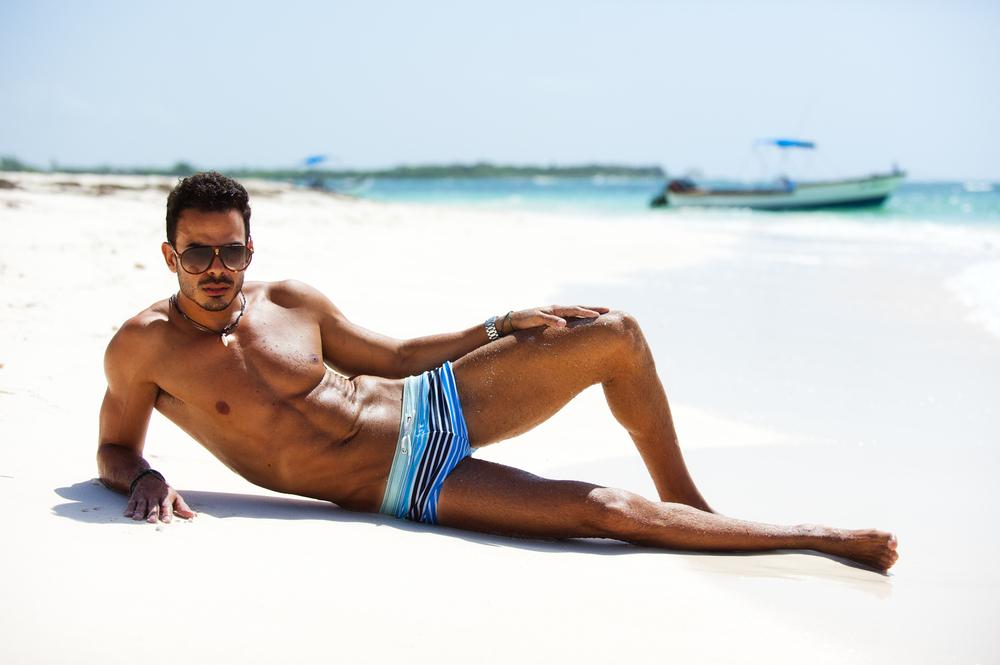 Stylish man wearing sunglasses in a beach.