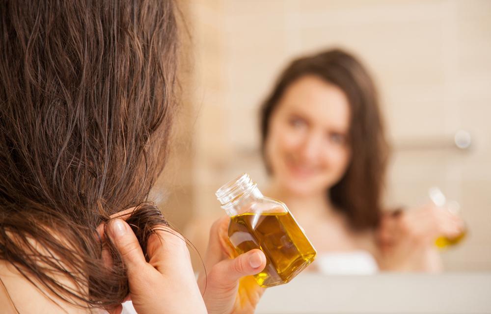 Woman applying hair oil