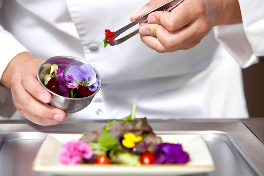 chef decorating with edible flowers