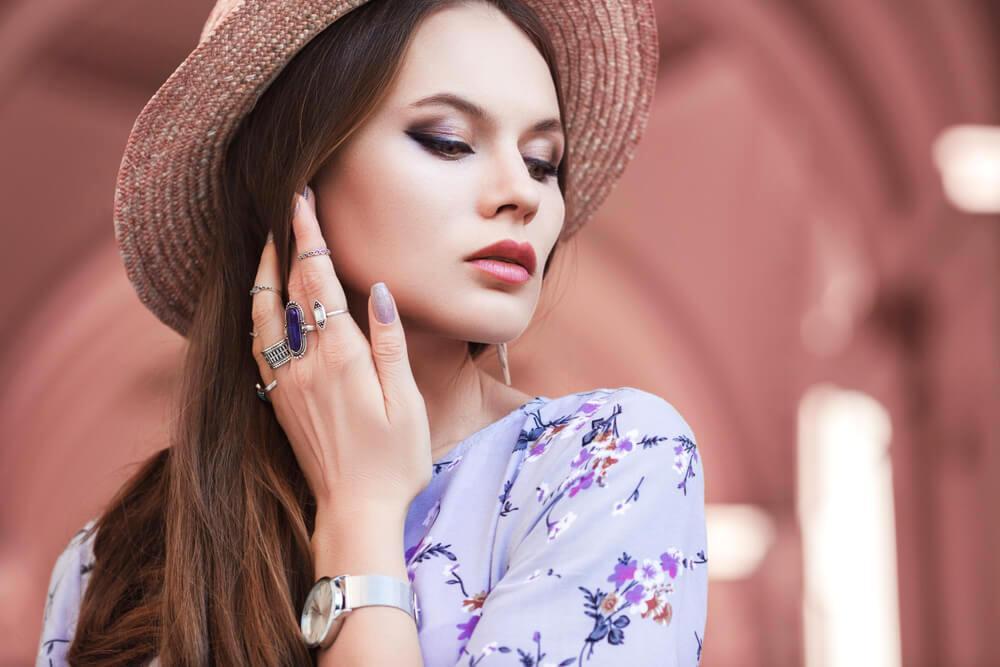 Young fashionable woman with rings on fingers and a watch