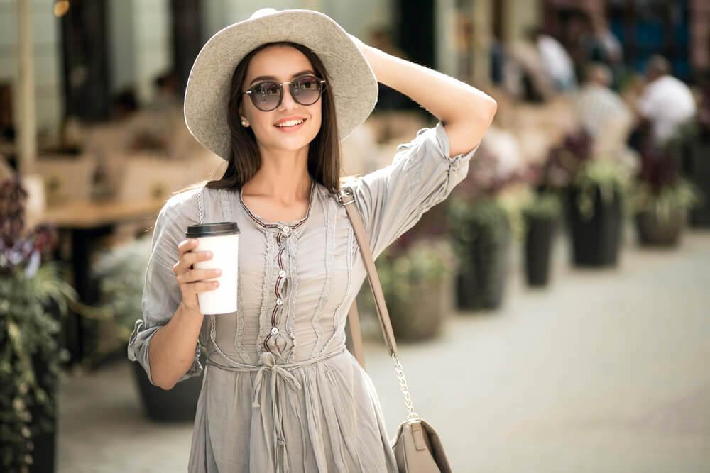 Young woman outdoors with hat and sunglasses