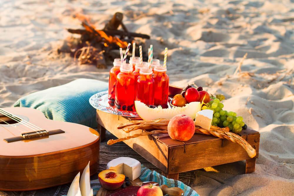Drinks and fruit on a platter, beach picnic 