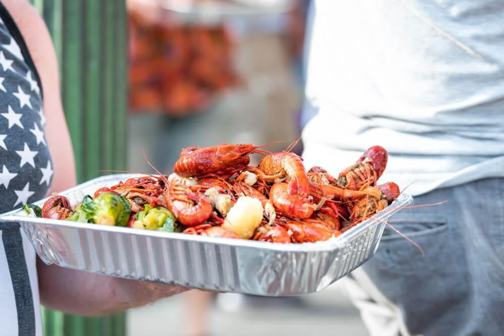 Woman holding plate of food outdoors