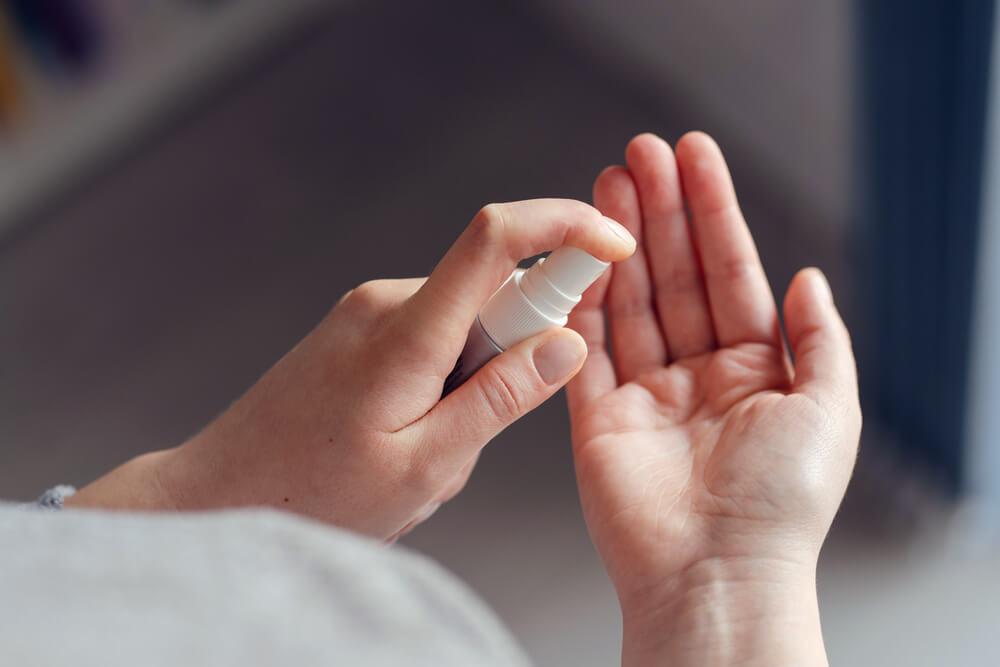 Hands using hand sanitizer