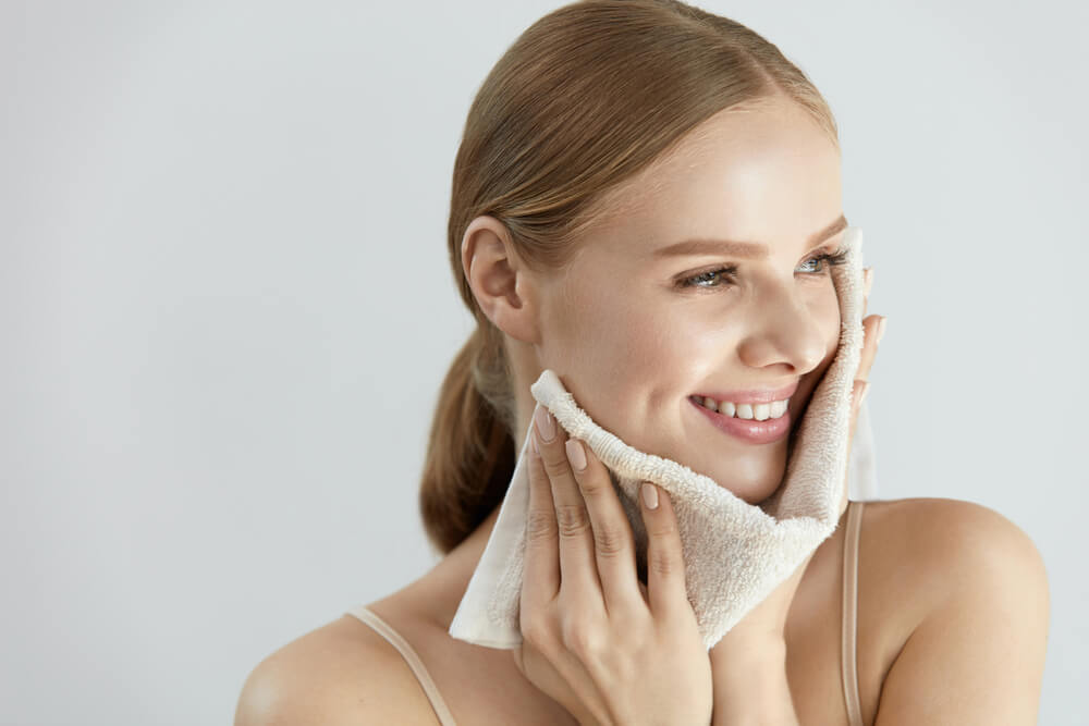 woman towel drying face