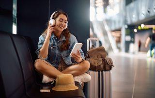 Woman listening to celebrity podcast while traveling