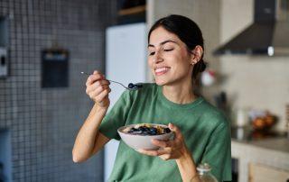 Woman eating fiber foods in bowl