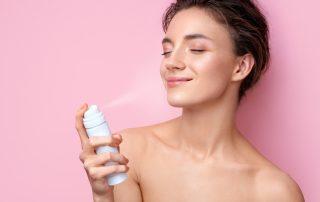 Woman spraying face